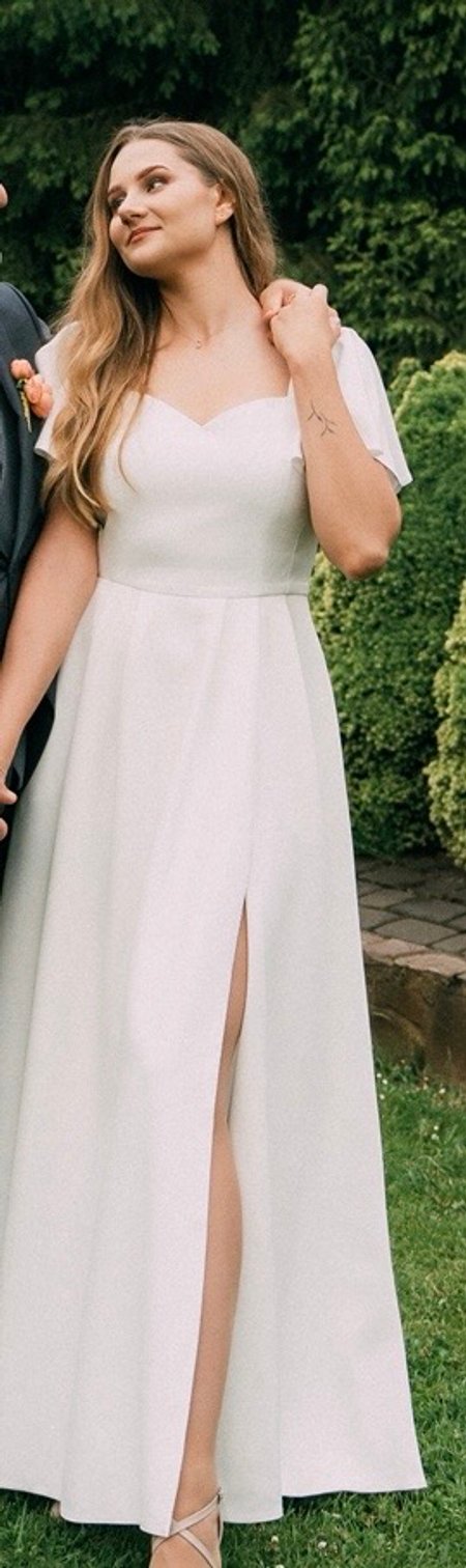 Loren - ecru gown with striking sleeves and leg slit