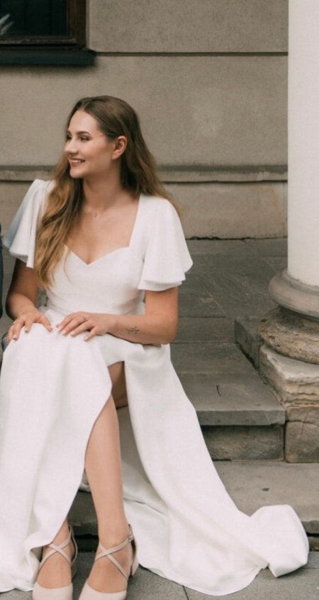 Loren - ecru gown with striking sleeves and leg slit