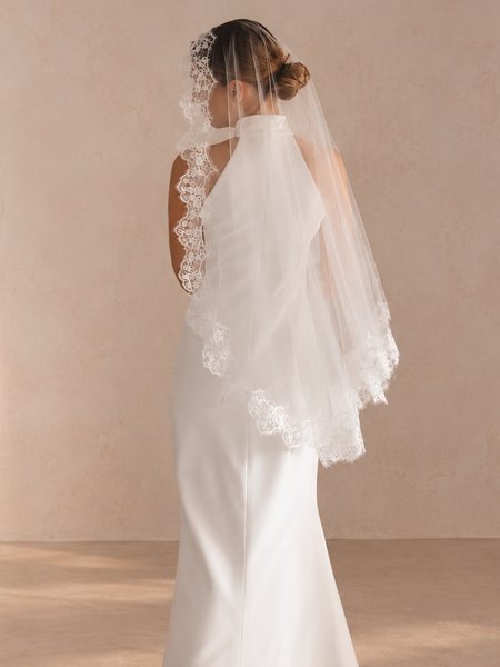 A short Spanish-style wedding veil with French lace in a light ecru color