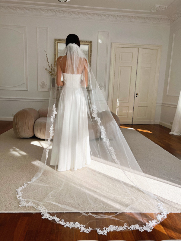 Long cathedral veil with floral lace on ecru edges