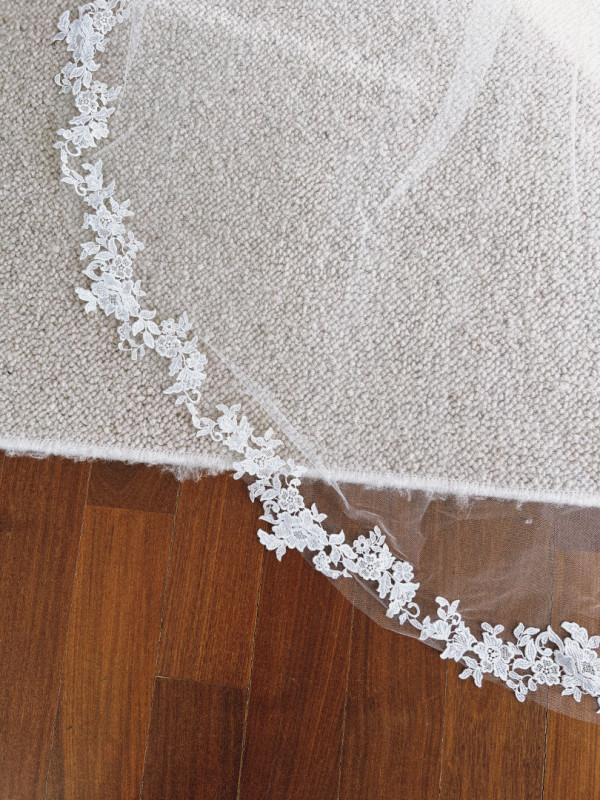 Long cathedral veil with floral lace on ecru edges